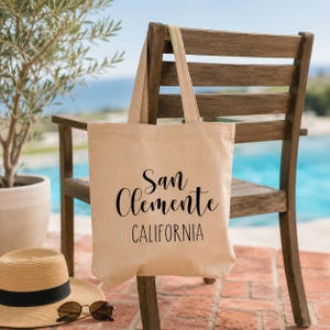 California Beach Gift Canvas Tote Bag San Clemente Souvenir Reusable Market Carrier Everyday Shopping Bag Coastal Town Design Minimalist Hand Lettered Style Durable Canvas Book Bag Perfect Farmers Market Grocery Tote Beach Day Essential