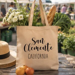 Beach Gift Canvas Tote San Clemente California Souvenir Bag Reusable Market Carrier Everyday Shopping Carryall Coastal Town Design Book Bag Durable Canvas Construction Minimalist Style Perfect Farmers Market Beach Day Grocery Tote Southern