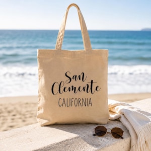 San Clemente California Canvas Tote Bag Coastal Beach Town Souvenir Gift Reusable Market Carrier Everyday Carryall Shopping Bag Minimalist Design Hand Lettered Typography Durable Canvas Construction Perfect Farmers Market Beach Day Book Bag
