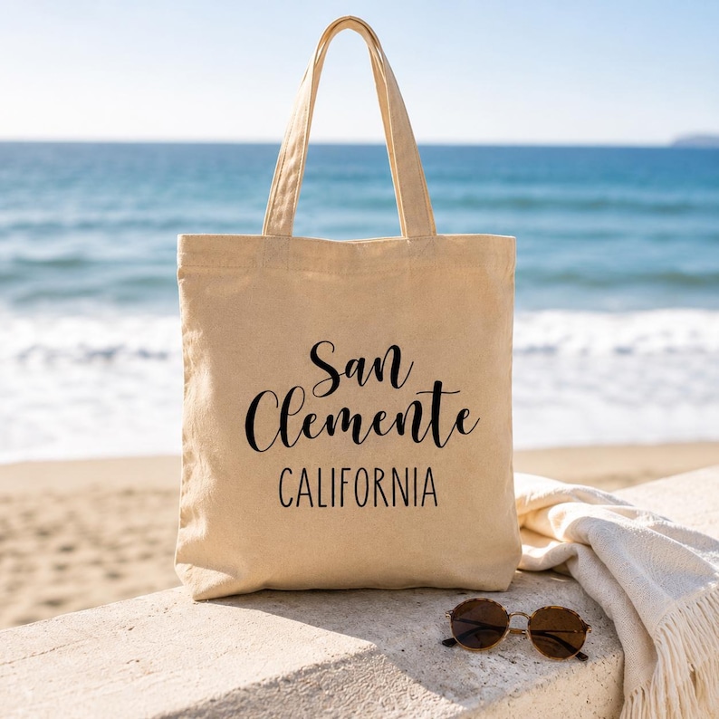 San Clemente California Canvas Tote Bag Coastal Beach Town Souvenir Gift Reusable Market Carrier Everyday Carryall Shopping Bag Minimalist Design Hand Lettered Typography Durable Canvas Construction Perfect Farmers Market Beach Day Book Bag