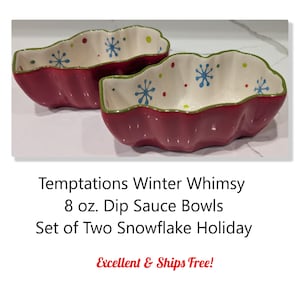 May include: Two red dip sauce bowls with a scalloped edge and snowflake design. The bowls have a white interior with blue snowflakes and red and green accents. The text on the image says "Temptations Winter Whimsy".
