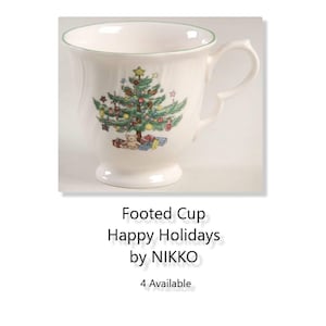 May include: White footed cup with a green rim and a Christmas tree design. The tree is decorated with ornaments, a star, and a teddy bear. The text "Footed Cup Happy Holidays by NIKKO" is printed below the image.