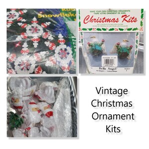 May include: Vintage Christmas ornament kits with instructions to make your own ornaments. The kits include white plastic angel ornaments with green and red details, and snowflake ornaments with red and white details. The kits are packaged in clear plastic bags.