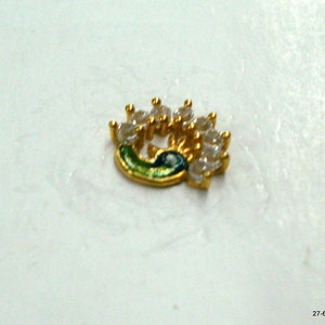 May include: Gold-toned nose ring shaped like a peacock with clear rhinestones.