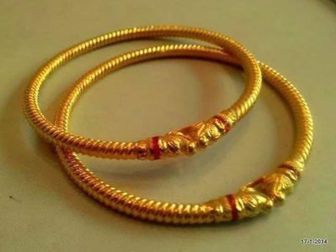 Gold bangles with copper rod inside best sale