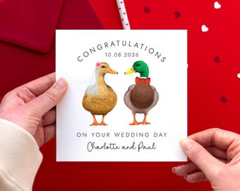 May include: A wedding card featuring two illustrated ducks, one in a veil and the other in a bow tie. The card reads "Congratulations 10.08.2026 On Your Wedding Day Charlotte and Paul."