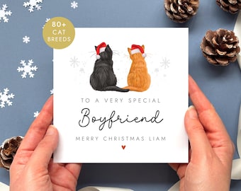 May include: A square greeting card featuring a black cat and an orange cat sitting side-by-side, both wearing red and white Santa hats. The text reads: TO A VERY SPECIAL Boyfriend MERRY CHRISTMAS LIAM with a small red heart below.