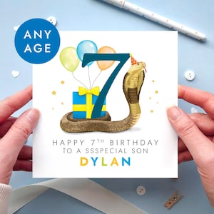May include: A square birthday greeting card featuring a large dark blue number 7, a brown cobra wearing a party hat, a blue gift box with a yellow ribbon, and three balloons. The text reads: ANY AGE, HAPPY 7TH BIRTHDAY TO A SSSPECIAL SON, DYLAN.