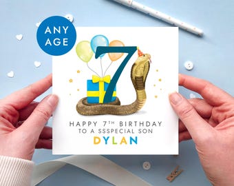 May include: A square birthday greeting card featuring a large dark blue number 7, a brown cobra wearing a party hat, a blue gift box with a yellow ribbon, and three balloons. The text reads: ANY AGE, HAPPY 7TH BIRTHDAY TO A SSSPECIAL SON, DYLAN.