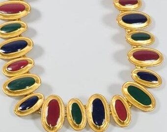 May include: A gold necklace with oval-shaped links, each featuring a different colored enamel inlay: red, green, and blue.