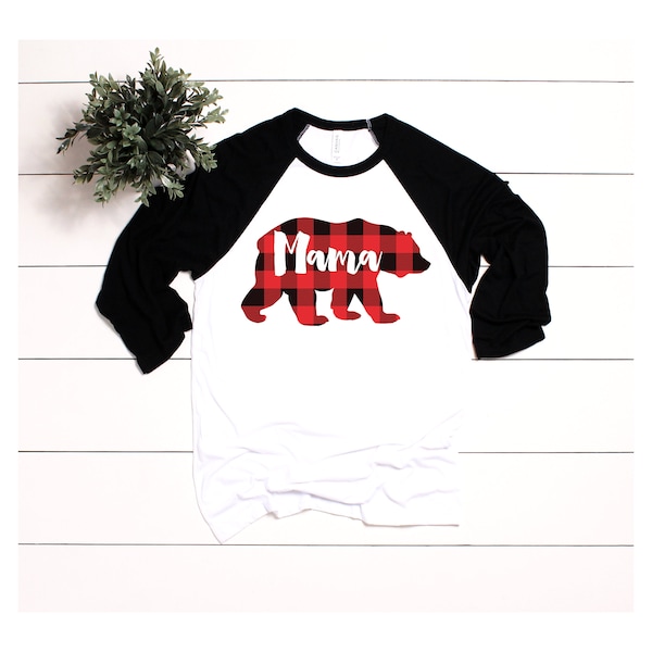 May include: A white and black baseball tee shirt with a red and black buffalo plaid bear silhouette with the word "Mama" inside the bear. 