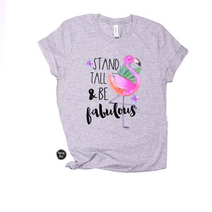 May include: Grey t-shirt with a pink flamingo illustration and the text "Stand Tall & Be Fabulous".