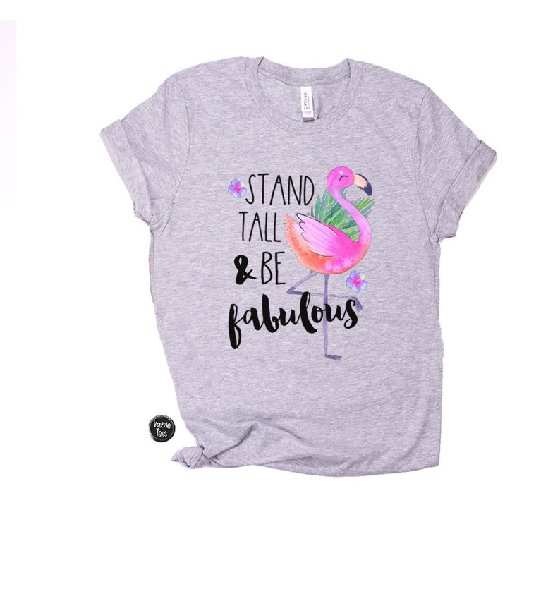 May include: Grey t-shirt with a pink flamingo illustration and the text "Stand Tall & Be Fabulous".