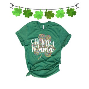 May include: Green t-shirt with a white shamrock design and the text "One Lucky Mama".