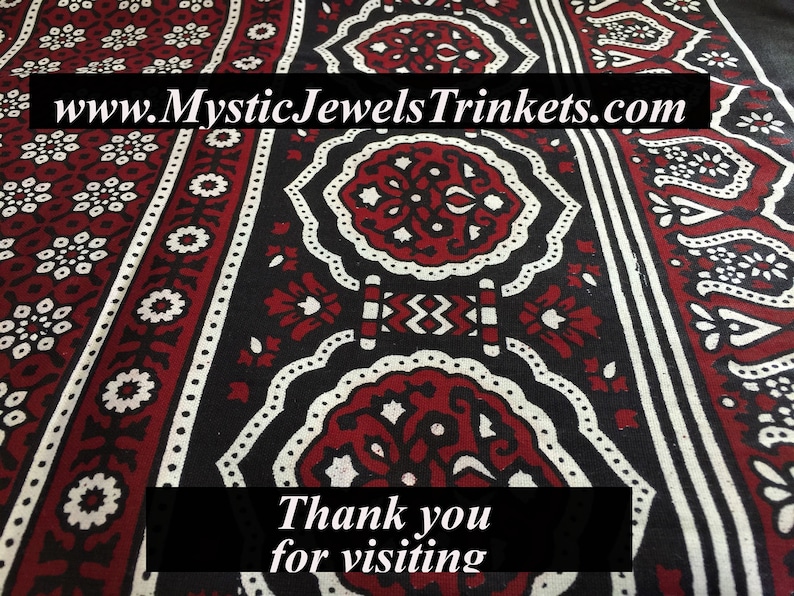 May include: A close-up of a red and white patterned fabric with a black background. The fabric has a traditional design with intricate details. The text "www.MysticJewelsTrinkets.com" is visible at the top of the image. The text "Thank you for visiting" is visible at the bottom of the image.