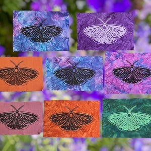 May include: Eight rectangular fabric patches featuring moth illustrations. The patches display various tie-dye patterns in shades of blue, purple, orange, pink, and green, with black or white moth prints centered on each piece of fabric.