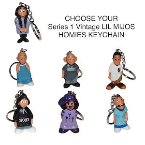 May include: A collection of Series 1 Vintage Lil Mijos Homies keychains. Each keychain features a small, colorful figurine with unique outfits and expressions. The text "CHOOSE YOUR Series 1 Vintage LIL MIJOS HOMIES KEYCHAIN" is displayed.