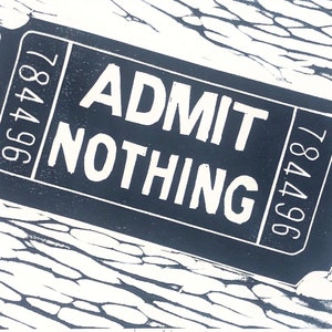 May include: A black and white ticket with the text "ADMIT NOTHING" and the numbers "784496" on either side.