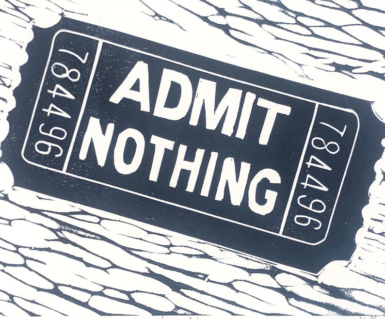 May include: A black and white ticket with the text "ADMIT NOTHING" and the numbers "784496" on either side.