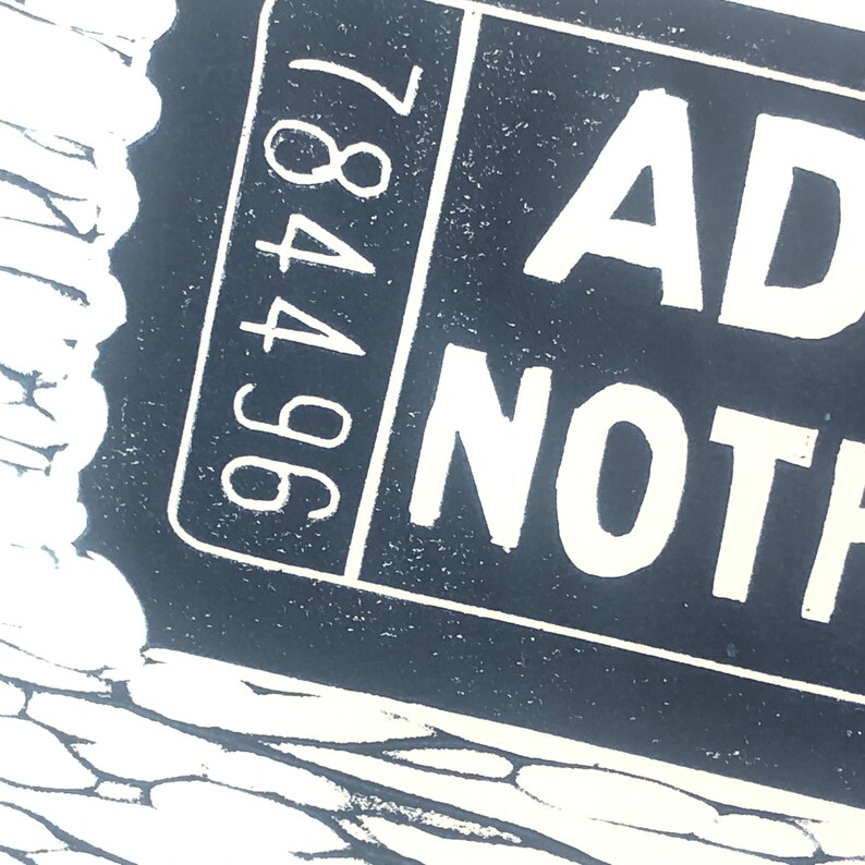 May include: Black and white image of a ticket with the text "ADMIT NOTHING" and the number "96487" printed on it.