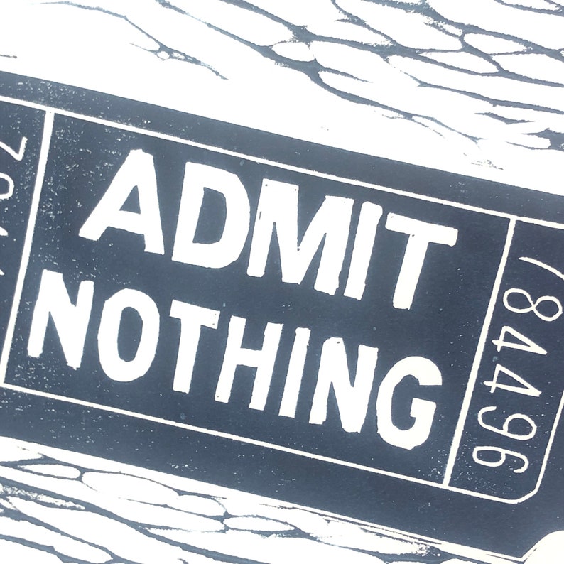 May include: A black and white ticket with the text "ADMIT NOTHING" and the number "964748" printed on it.