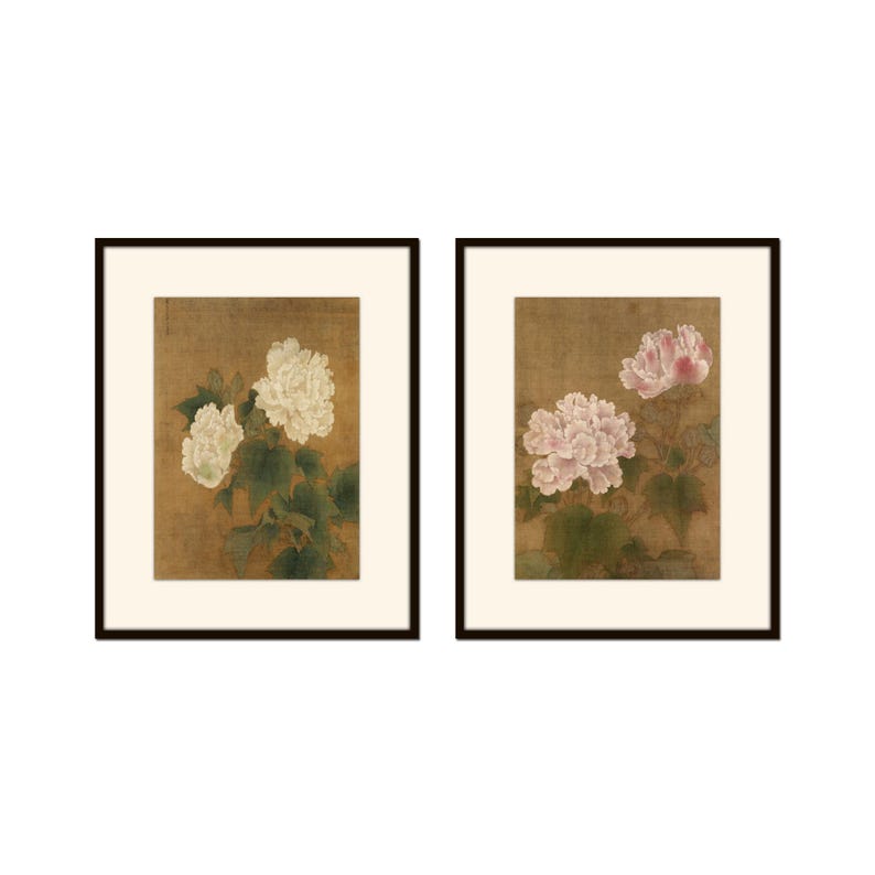 May include: Two framed prints of delicate floral paintings. The left print features white flowers with green leaves on a beige background. The right print features pink flowers with green leaves on a beige background.