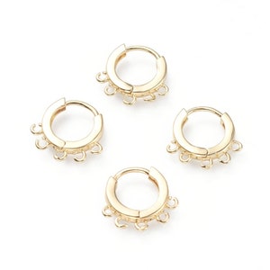 May include: Four gold-toned hoop earrings with five jump rings attached to each hoop.