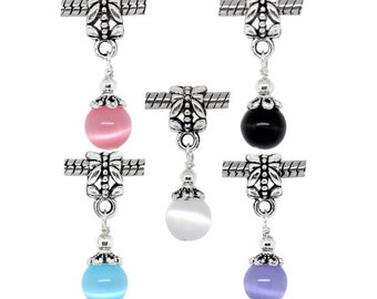 May include: Five silver charm beads with a dangling round bead in pink, black, white, light blue, and purple. Each bead has a butterfly design.
