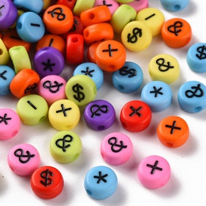 May include: Assortment of colorful plastic alphabet beads with various letters and symbols. The beads are round and have a smooth, glossy finish.