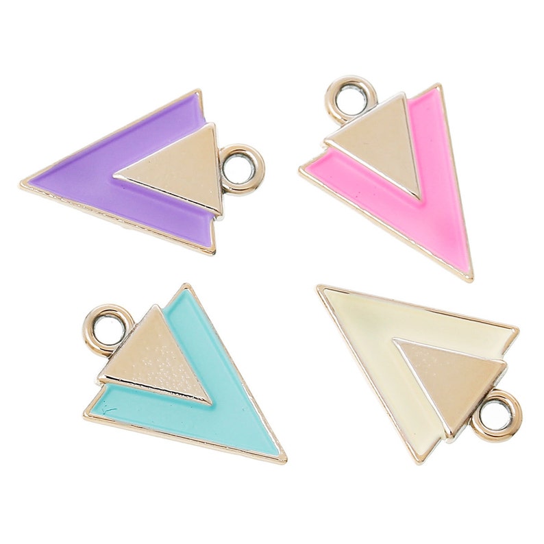 May include: Four silver triangle charms with different colored enamel inlays. The charms are purple, pink, light blue, and cream.