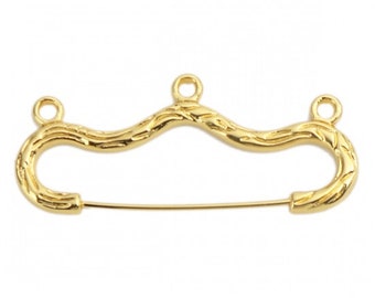 May include: Gold-toned metal safety pin with a wavy, textured design and three loops at the top.