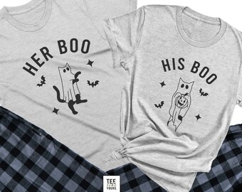 May include: A matching set of gray t-shirts with a black and white ghost graphic and the text "Her Boo" and "His Boo". The shirts are paired with black and gray plaid pajama pants.