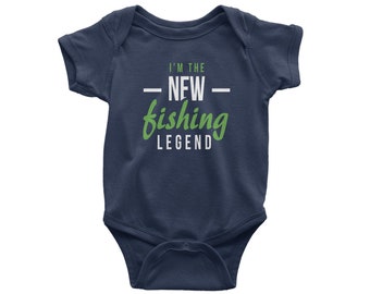 May include: Navy blue baby onesie with the text "I'M THE NEW fishing LEGEND" in white and green. The onesie has short sleeves and a snap closure.