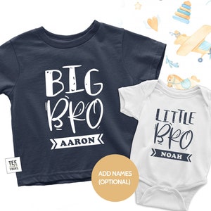 May include: Two white t-shirts with a blue and white design. The larger shirt says "BIG BRO" with the name "AARON" underneath. The smaller shirt says "LITTLE BRO" with the name "NOAH" underneath.