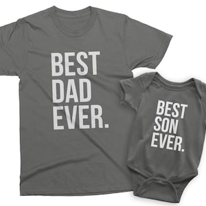 May include: A gray t-shirt with the text "Best Dad Ever." and a gray baby bodysuit with the text "Best Son Ever."