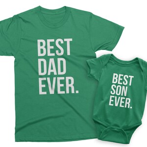 May include: A green t-shirt with the text "BEST DAD EVER." and a green baby onesie with the text "BEST SON EVER."