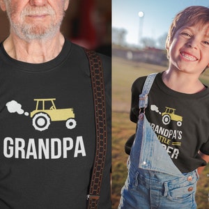 May include: Black t-shirt with a white tractor graphic and the text "Grandpa's Little Helper".