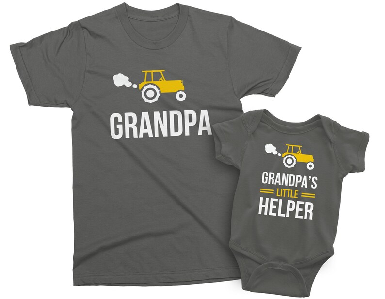 May include: A gray t-shirt with the text "Grandpa" and a yellow tractor graphic. A matching gray baby onesie with the text "Grandpa's Little Helper" and a yellow tractor graphic.