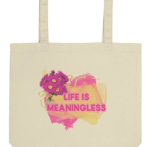 May include: A beige tote bag with a pink and yellow watercolour design. The design features a bouquet of pink flowers and the text "LIFE IS MEANINGLESS".