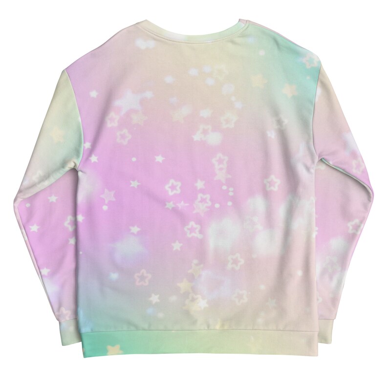 May include: A pastel pink, green, and yellow sweatshirt with a tie-dye effect and white stars and clouds printed on it.
