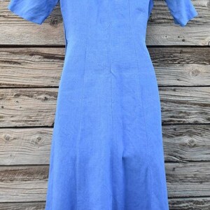 May include: A light blue linen dress with a back zipper and a slightly flared skirt.