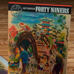 May include: A vintage San Francisco Forty Niners football game ticket from December 10, 1950. The ticket features a cartoon illustration of a Japanese pagoda and people in a park setting. The ticket is for Norm Standlee Day at Kezar Stadium.