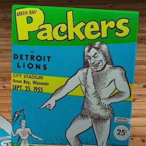 May include: Green Bay Packers vs. Detroit Lions game program from September 25, 1955. The program features a cartoon illustration of a large, muscular man pointing to a smaller football player. The program is priced at 25 cents.