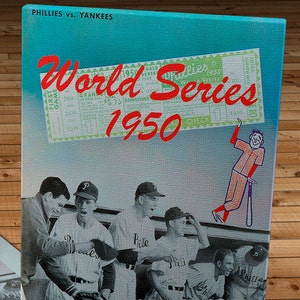 May include: A vintage World Series program cover from 1950 featuring the Philadelphia Phillies and the New York Yankees. The cover features a red and white ticket with the text "World Series 1950" and a cartoon baseball player holding a bat.