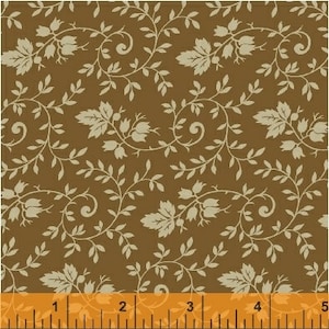 May include: A brown fabric with a repeating pattern of beige leaves and flowers. The fabric is shown with a ruler for scale.