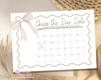 May include: A rectangular paper game card titled Guess the Due Date with a beige scalloped border and a large beige bow in the top left corner. The card features a calendar for September and October 2024 with Sophie's Due Date: 29th September, 2024.