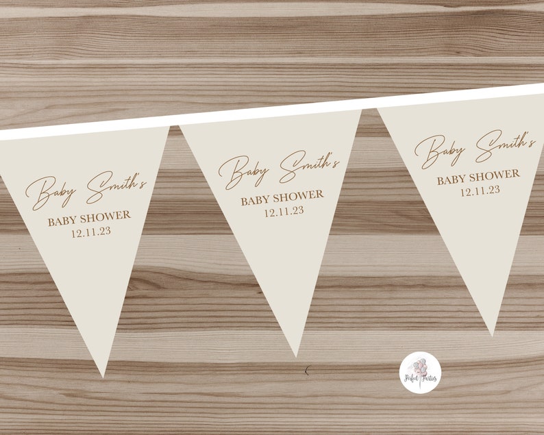 May include: Three beige triangle-shaped pennants with the text "Baby Smith's Baby Shower 12.11.23" on each pennant.