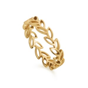 May include: A gold-toned ring with a delicate leaf design. The ring is made of metal and has a simple, elegant style.