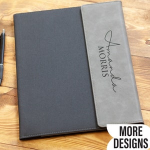May include: A gray and black leather folder with a personalized inscription that reads "Amanda Morris".