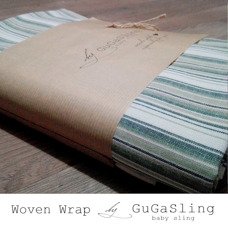 May include: A woven baby wrap in a green and white striped pattern, packaged in brown paper with a label that reads "by GuGaSling baby sling".